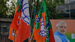 Supporters of Bharatiya Janata Party (BJP) hold party flags as they celebrate Narendra Modi’s swearing-in ceremony on June 9, 2024. 