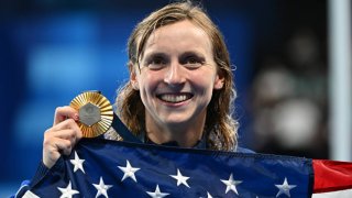 U.S. swimmer Katie Ledecky smiles with her gold medal after winning the Women’s 1500m Freestyle final at the Paris 2024 Olympics on July 31, 2024. Ledecky swam at Stanford University, which has the most Olympic athletes of any college in the Games.