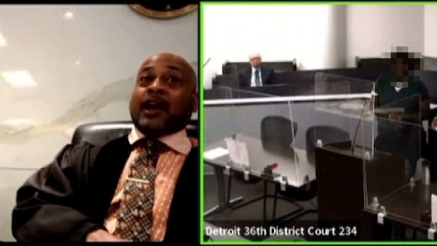 Closed circuit footage of a judge and courtroom.