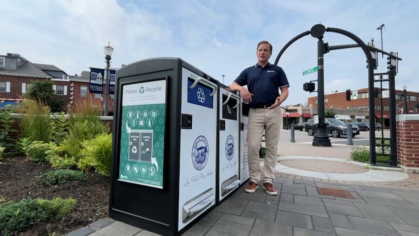 Bigbelly founder Jeff Satwicz stands with his company’s solar, compacting trash cans