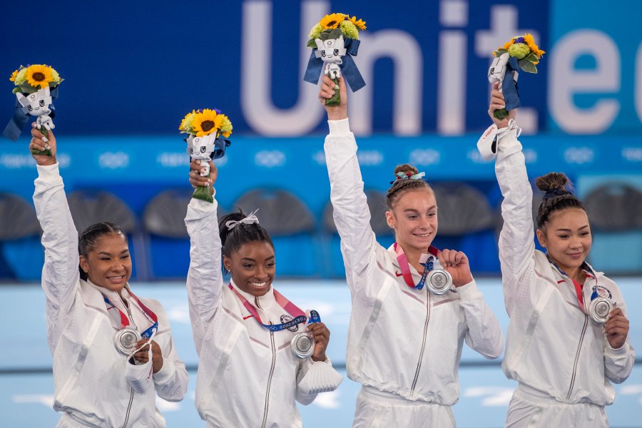 Biles stands with her teammates Jordan Chiles, Grace McCallum and  Sunisa Lee