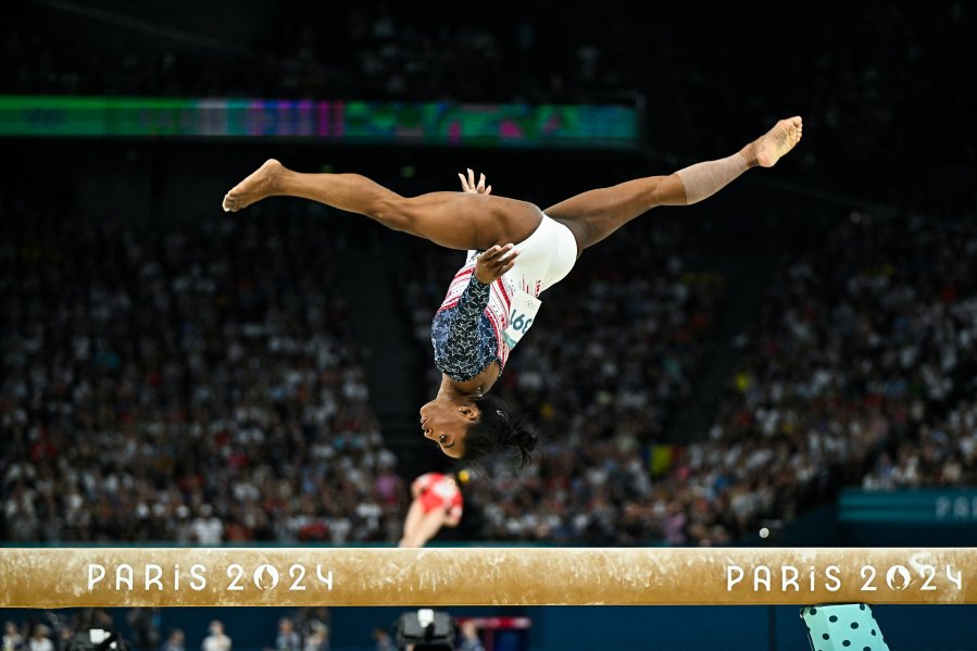 Biles performs on beam