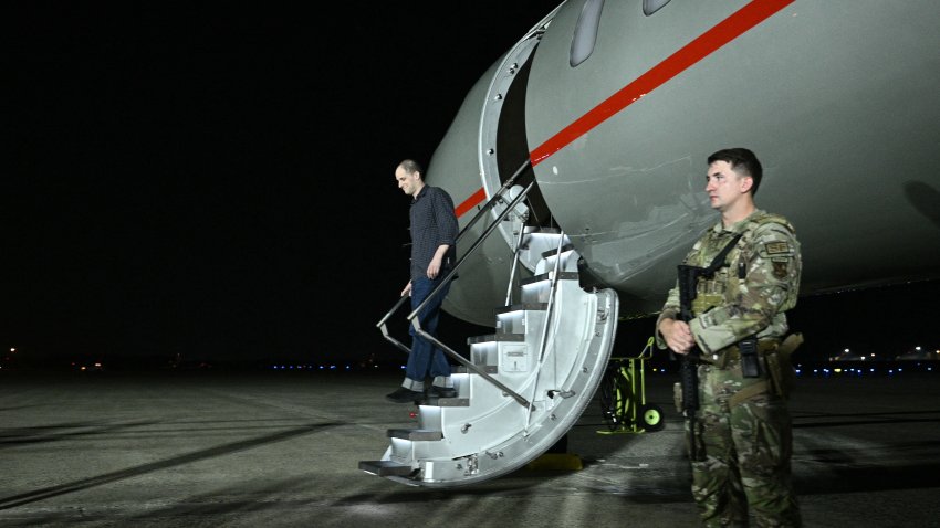 Former prisoner held by Russia US journalist Evan Gershkovich steps off the plane as he arrives at Joint Base Andrews in Maryland on August 1, 2024.