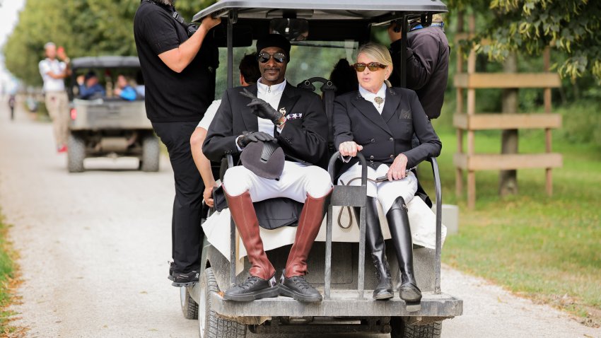 Snoop Dogg and Martha Stewart ride a gold cart together in matching horseback riding outfits