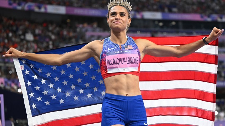 Sydney McLaughlin-Levtrone wears an American flag and tiara after winning Olympic gold