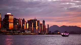 Crimson clouds light up the skyline of Victoria Harbour on July 14, 2022 in Hong Kong, China.