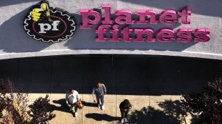 In an aerial view, customers leave a Planet Fitness gym on May 09, 2024 in Richmond, California. 