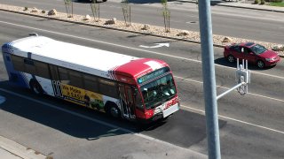 A commuter bus equipped with a radio transmitter approaches a connected traffic light on Redwood Road in Salt Lake City, part of an effort to improve safety and efficiency by allowing cars to communicate with the roadside infrastructure and one another, Friday, Sept. 6, 2024, near Taylorsville, Utah.