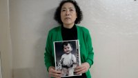 Choi Young-ja holds a photo of her son, who went missing in 1975, in her motel room in Seoul, South Korea, Tuesday, March 5, 2024.