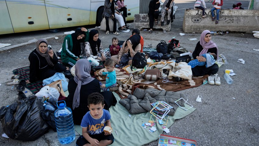 Families sit on the ground in Martyrs' square