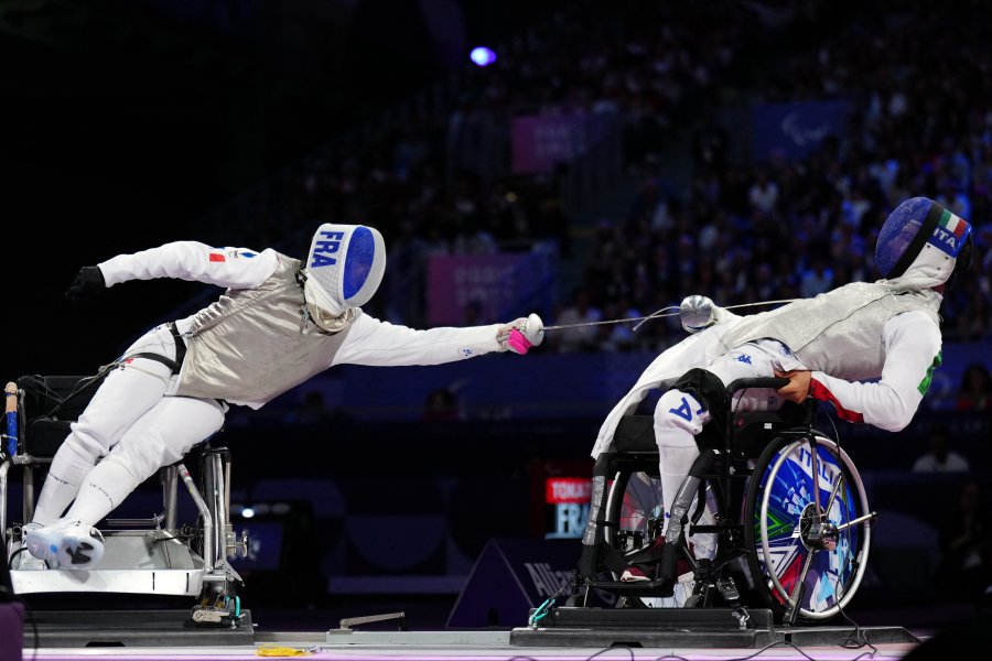 France's Damien Tokatlian competes against Italy's Emanuele Lambertini in the wheelchair fencing men's foil team bronze medal match between France and Italy during the Paris 2024 Paralympic Games at the Grand Palais in Paris on September 5 2024