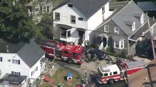 Firefighters respond to a fire at a home in Woburn, Massachusetts, on Sept. 11, 2024.