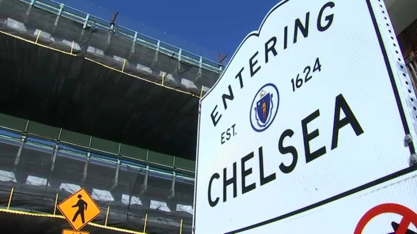 Repair work on the Tobin Bridge seen beyond a "Welcome to Chelsea" sign in Chelsea, Massachusetts.