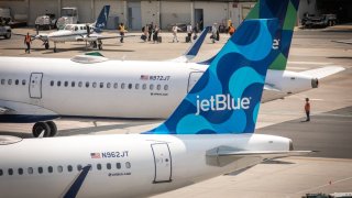 JetBlue planes at Logan Airport. The carrier has begun a new daily flight to Presque Isle, Maine, and will soon launch one to Manchester, New Hampshire.