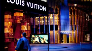 A man passes a Louis Vuitton store in Macau, China, on Friday, Dec. 10, 2010.