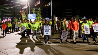 Workers picket outside the APM container terminal at the Port of Newark in Newark, New Jersey, US, on Tuesday, Oct. 1, 2024. 