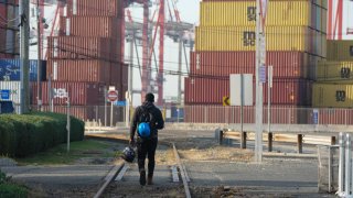 A man walks along the railroad tracks at Port Newark in New Jersey, on October 4, 2024. 