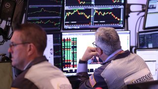 Traders work on the floor of the New York Stock Exchange during morning trading in New York City. 