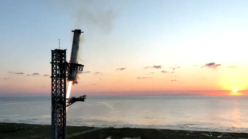 The Super Heavy booster lands on the company’s launch tower during the fifth Starship flight on Oct. 13, 2024.