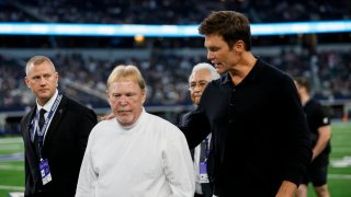 Las Vegas Raiders owner Mark Davis walks off the field with former NFL quarterback Tom Brady before the preseason game between the Dallas Cowboys and the Las Vegas Raiders at AT&T Stadium in Arlington, Texas, on Aug. 26, 2023.