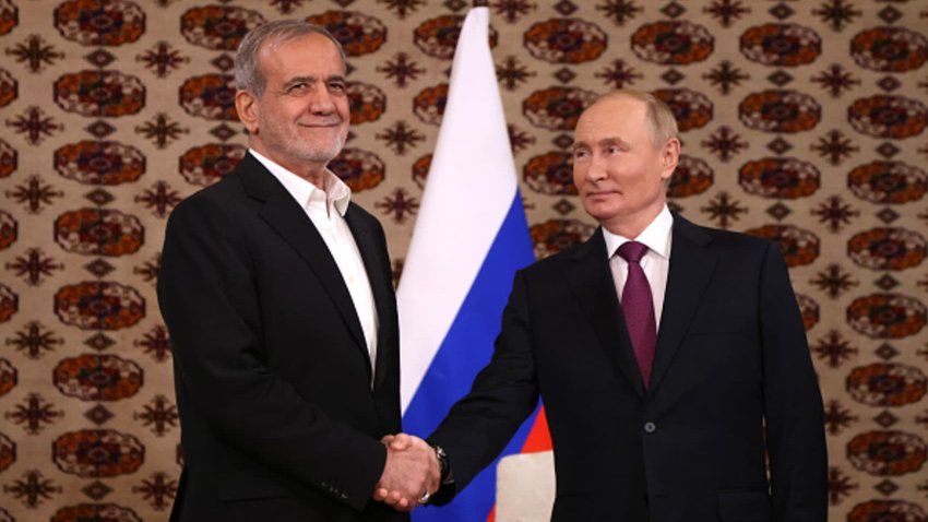 Russian President Vladimir Putin (R) shakes hands with Iranian President Masoud Pezeshkian (L) during their meeting, October 11, 2024, in Ashgabat, Turkmenistan.