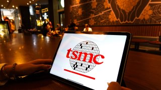 In this photo illustration, a TSMC logo is displayed on the screen of a smartphone. 