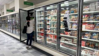 A customer shops in the ready to eat meals aisle of a grocery store on October 17, 2024 in Miami, Florida. 