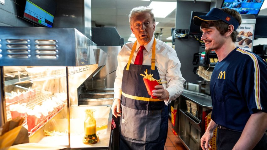 Republican presidential nominee and former U.S. President Donald Trump works behind the counter during a visit to McDonalds in Feasterville-Trevose, Pennsylvania, U.S. October 20, 2024. 