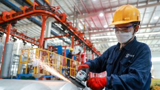 JIUJIANG, CHINA – JUNE 17: A worker manufactures seamless steel gas cylinders for export at the workshop of Sinoma Science & Technology (Jiujiang) Co., Ltd. on June 17, 2024 in Jiujiang, Jiangxi Province of China.  