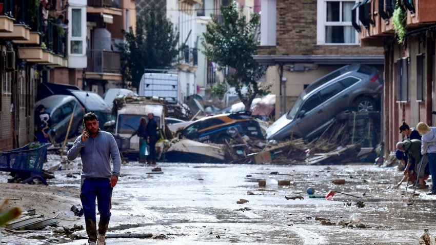 A man walks in the aftermath of flash floods in Spain