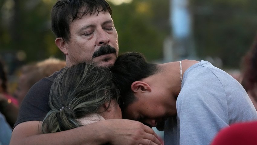 Daniel Delgado, top, is comforted by his 16-year-old son Angel Delgado, right, as he mourns the loss of his wife and Angel's mother, Monica Hernandez, who died at Impact Plastics during flooding caused by Hurricane Helene in Erwin, Tenn., on Thursday, Oct. 3, 2024.