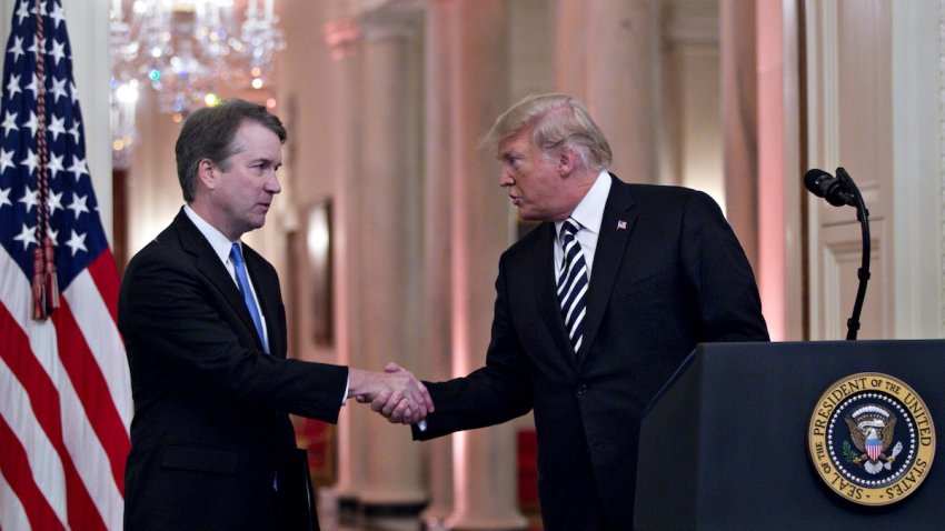 File – President Donald Trump, right, shakes hands with Brett Kavanaugh, associate justice of the U.S. Supreme Court, during a ceremonial swearing-in event in the East Room of the White House in Washington, D.C., U.S., on Monday, Oct. 8, 2018.