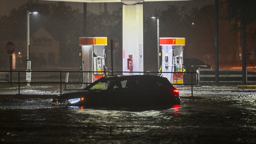 A vehicule is stranded on a water-flooded street after Hurricane Milton made landfall in Brandon, Florida on October 9, 2024. Milton made landfall in Florida October 9, 2024 as an “extremely dangerous” Category 3 hurricane, packing life-threatening storm surge, extreme winds and flash flooding, the National Hurricane Center (NHC) said. “Data indicate the eye of Hurricane Milton has made landfall near Siesta Key in Sarasota County along the west coast of Florida,” the NHC said in an 8:30 pm (0030 GMT Thursday) bulletin. (Photo by Miguel J. Rodriguez Carrillo / AFP) (Photo by MIGUEL J. RODRIGUEZ CARRILLO/AFP via Getty Images)