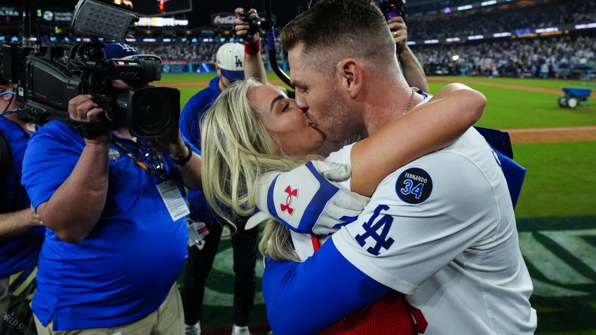 LOS ANGELES, CA - OCTOBER 25: Freddie Freeman #5 of the Los Angeles Dodgers celebrates with his wife after hitting a walk-off grand slam in the tenth inning of Game 1 of the 2024 World Series presented by Capital One between the New York Yankees and the Los Angeles Dodgers at Dodger Stadium on Friday, October 25, 2024 in Los Angeles, California. The Los Angeles Dodgers won 6-3.(Photo by Daniel Shirey/MLB Photos via Getty Images)