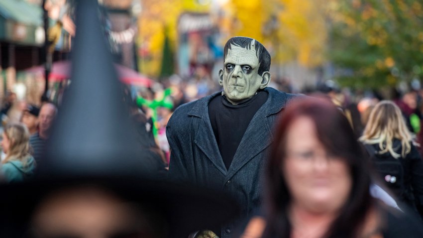 A costumed reveler dressed as Frankenstein’s monster, walks amond people celebrating Halloween Eve in Salem, Massachusetts on October 30, 2024. (Photo by Joseph Prezioso / AFP) (Photo by JOSEPH PREZIOSO/AFP via Getty Images)