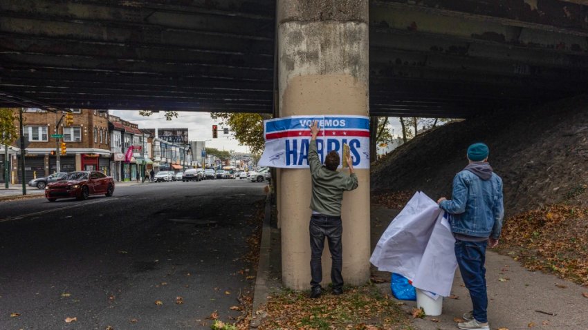 Supporters of Kamala Harris put up posters in Latino neighborhoods in Philadelphia on Oct. 14