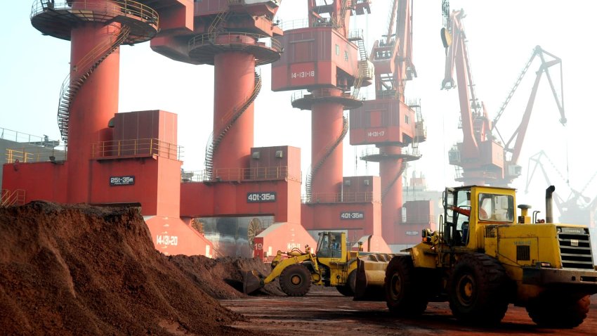 Workers transporting soil containing rare earth elements for export at a port in Lianyungang, Jiangsu province, China, Oct. 31, 2010.