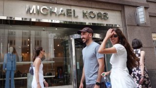 Pedestrians walk past a Michael Kors store on August 10, 2023 in Chicago, Illinois. 