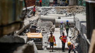 Construction workers in Mumbai, India, on June 5, 2024. 