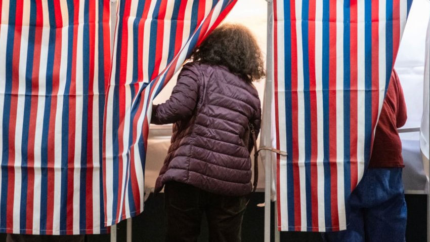 People enter voting booths at a polling station at Colebrook Academy and Elementary School in Colebrook, New Hampshire, on Election Day, November 5, 2024.