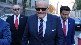 Rudy Giuliani (C) arrives at the New York court following a judge’s order compelling his appearance in the defamation case filed by Georgia election workers in New York, United States on November 07, 2024.