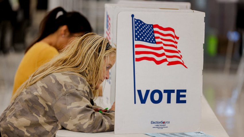 A woman completes her ballot for the 2024 U.S. presidential election at a polling booth in Fairfax, Virginia on November 5, 2024.