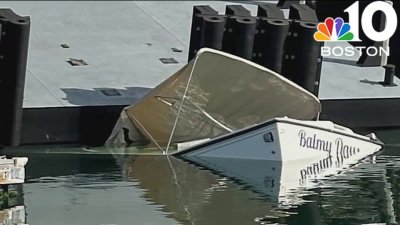 Crane drops barge onto boat in East Boston marina