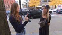 Clare Olson interviewing a woman in Boston about the Massachusetts State Police.