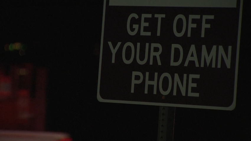 Traffic sign that says "get off your damn phone"