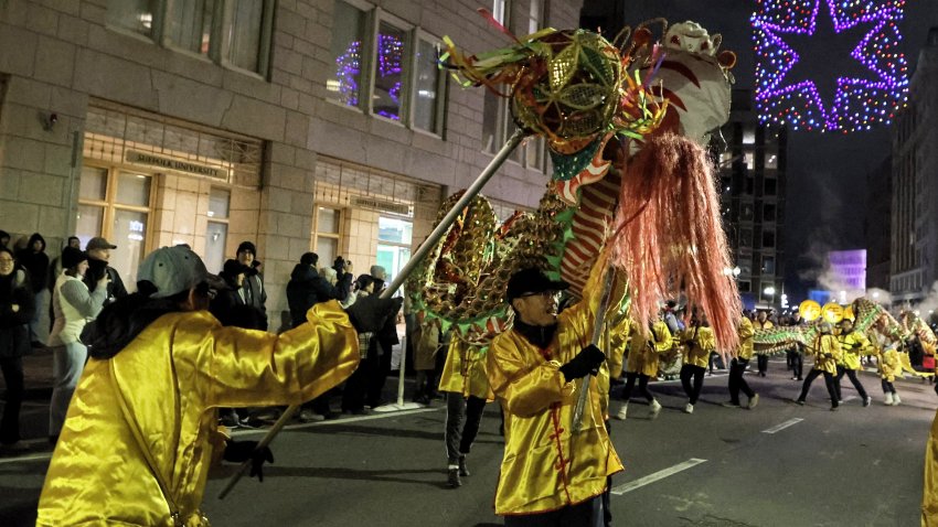 Boston, MA – December 31: Dragon dancers from the Greater Boston Chinese Cultural Association make their way down Boylston Street during the First Night procession. (Photo by Matthew J. Lee/The Boston Globe via Getty Images)