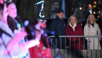 (From L) US President Joe Biden, US First Lady Jill Biden, and daughter-in-law Melissa Cohen Biden watch as carolers perform during a Christmas tree lighting in Nantucket, Massachusetts, on November 29, 2024. Biden and family are in Nantucket, Massachusetts, for the Thanksgiving holiday. (Photo by Mandel NGAN / AFP) (Photo by MANDEL NGAN/AFP via Getty Images)