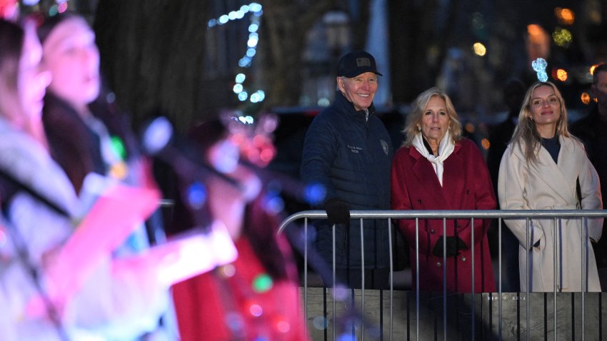 (From L) US President Joe Biden, US First Lady Jill Biden, and daughter-in-law Melissa Cohen Biden watch as carolers perform during a Christmas tree lighting in Nantucket, Massachusetts, on November 29, 2024. Biden and family are in Nantucket, Massachusetts, for the Thanksgiving holiday. (Photo by Mandel NGAN / AFP) (Photo by MANDEL NGAN/AFP via Getty Images)