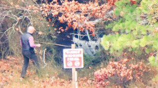 Police are investigating a scene in a wooded area in Sandwich, Massachusetts, on Monday, Nov. 11, 2024.