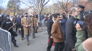 Men who participated in an anti-abortion rally at the Boston Common walking through a police escort on Saturday, Nov. 16, 2024.